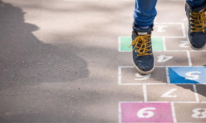 Young person playing hopscotch